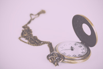 Pocket watch against a light background Vintage Retro Filter.
