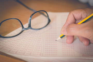 optical form of an examination with pencil and glasses, filling