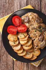 Diana steak with mushrooms and cream sauce close-up. Vertical top view
