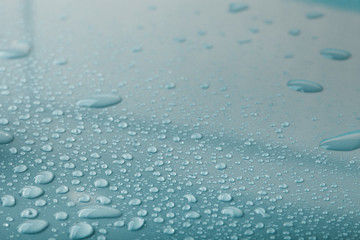 Drops of water on a color background. Gray. Shallow depth of fie