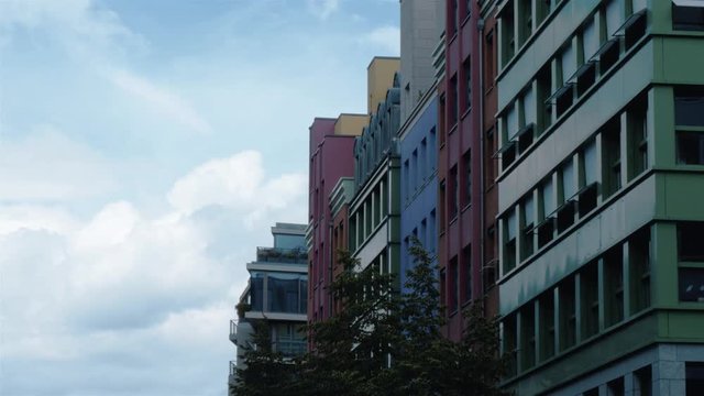 Real time locked down medium shot of the Street view of the row of colourful buildings at  Charlottenstrasse with Quartier Quartier at background.
