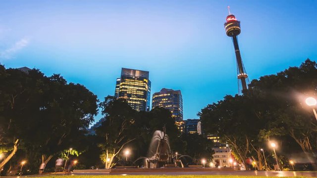 Day to night Sydney cityscape view from Hyde Park. Pan left