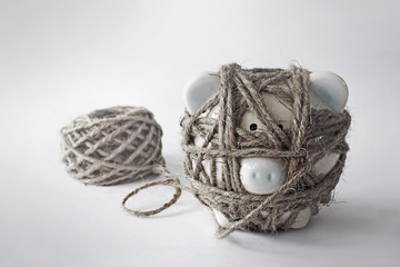 The concept of saving Piggy bank tied ropes