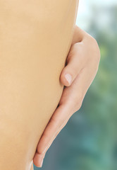 Attractive woman with her hands on her belly