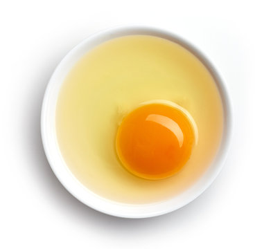 Bowl of egg yolk isolated on white, from above