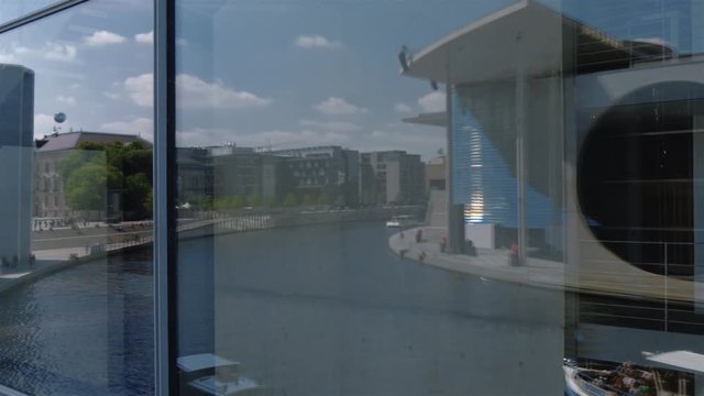 Real time Window Reflection locked down shot of the new parliamentary complex in the government quarter at the Spree River in Berlin, Germany.
