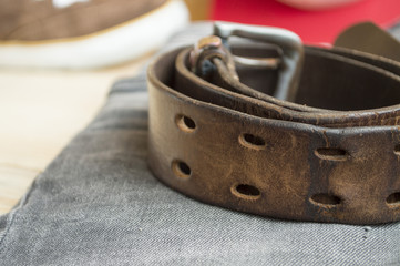 rough leather belt on jeans background