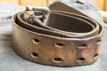 rough leather belt on jeans background