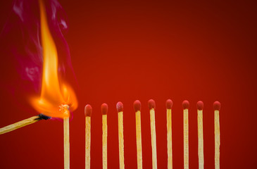 Burning matchsticks setting fire to its neighbors