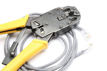 Crimping tool and network cable on white background