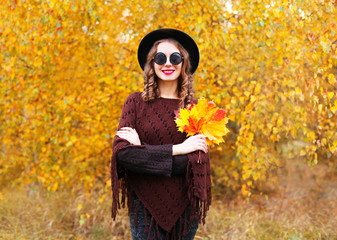 Autumn portrait fashion smiling woman wearing a black hat knitte