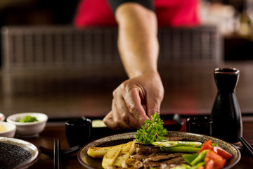 The festive crab dish being garnished