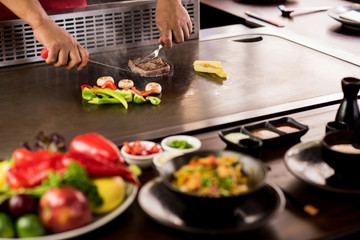 Chef preparing dishes in restaurant.
