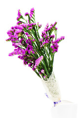 Bouquet from purple statice flowers arrangement centerpiece in vase isolated on white background.