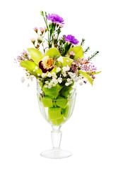 Floral bouquet of orchids, roses and carnation arrangement centerpiece in glass vase isolated on white background