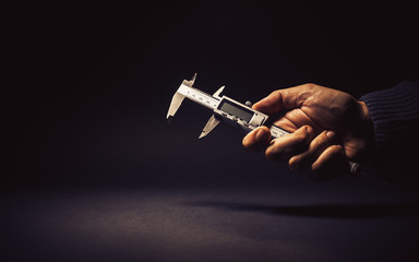 Male Hand Holding a Vernier Caliper