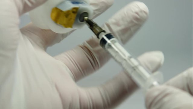 Nurse Hands Filling A Syringe With Medicine, Close Up, Detail