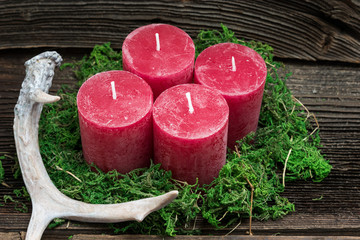 Christmascandles on a wooden Background