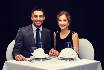 smiling couple holding hands at restaurant