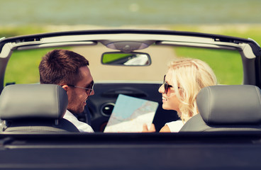 happy man and woman driving in cabriolet car