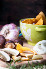 Sliced boletus with chanterelle and onion. Cooking musrooms
