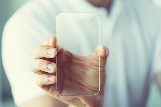 close up of male hand with transparent smartphone