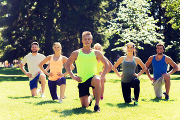 group of friends or sportsmen exercising outdoors