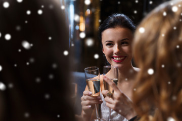 happy women with champagne glasses at night club