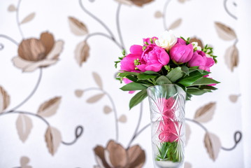 Luxurious pink, red and white peonies bouquet with leaves  buds in the crystal vase