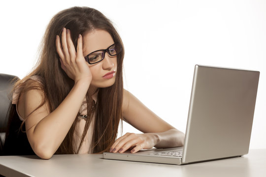 unhappy business woman looking at her laptop