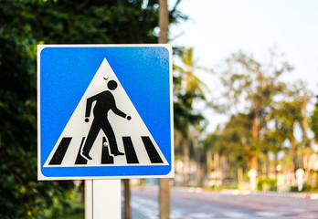 Blue pedestrian crossing sign