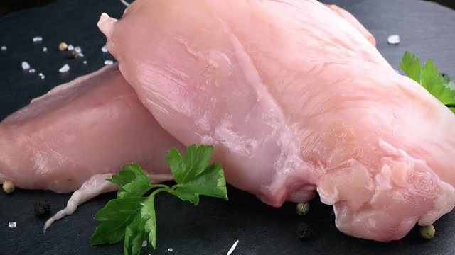 Piece of raw Chicken Fillet as rotating not loopable 4K clip