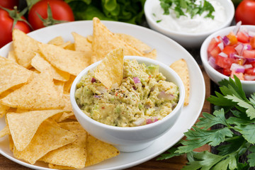 guacamole sauce and corn chips on plate