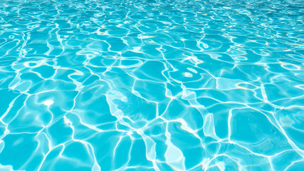 Fototapeta na wymiar Blue water surface in swimming pool
