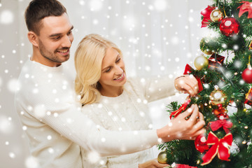 Fototapeta na wymiar happy couple decorating christmas tree at home