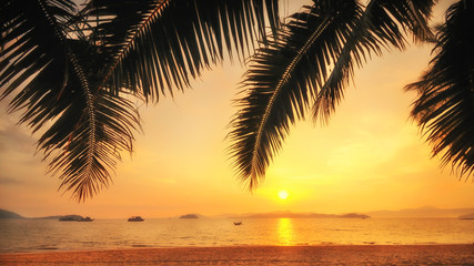 Naklejka na ściany i meble Sunrise on tropical beach background at Phayam island in Ranong province, Thailand. Happy summer holiday concept and soft focus idea