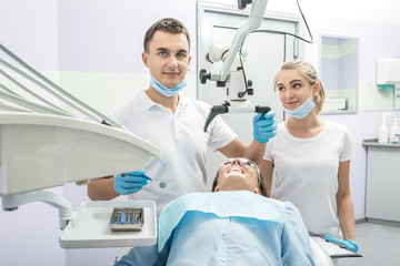 Dentist, assistant and patient in clinic
