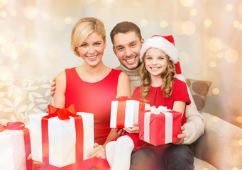 Fototapeta na wymiar smiling family holding many gift boxes