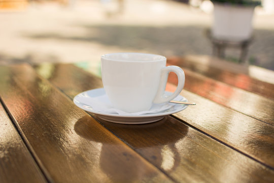 cup of coffee on a table at an outdoor cafe