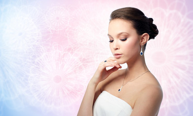 beautiful woman with earring, ring and pendant