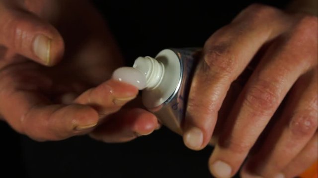 Hands Squeezing Cream Out Of A Tube, Close Up, Detail