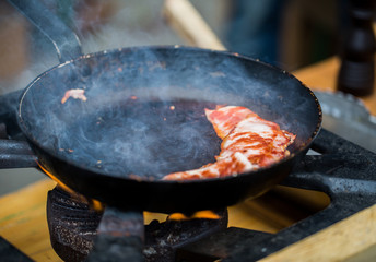 close up of food frying pan at street market