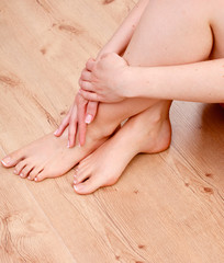 Obraz na płótnie Canvas pedicure on legs and beautiful manicure hands closeup