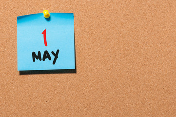 May 1st. Day 1 of month, calendar on cork notice board, business background. Spring time, empty space for text