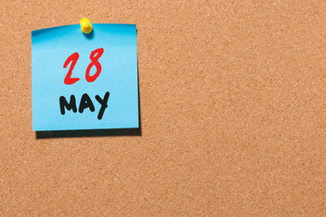 May 28th. Day 28 of month, calendar on cork notice board, business background. Spring time, empty space for text