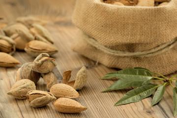 Almonds on brown wooden background