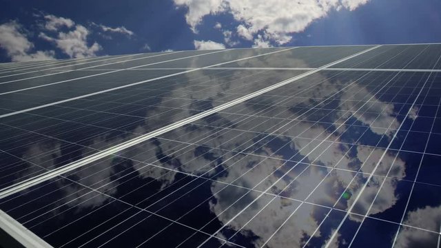 Solar panels with cloud reflection, time lapse