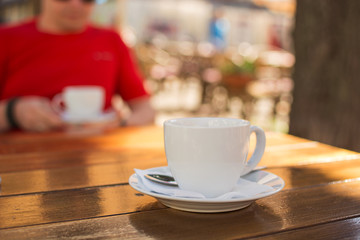 cup of coffee on a table at an outdoor cafe