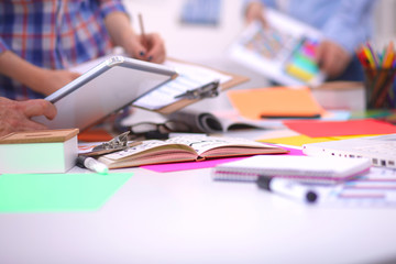 Close-up of three young creative designers working on project together. Team work