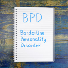 BPD- Borderline Personality Disorder written in notebook on wood